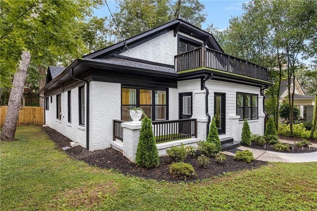 view of property exterior featuring a yard and a balcony