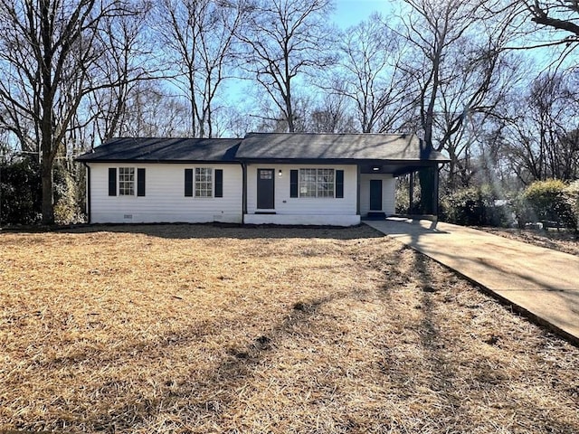 single story home with a front yard and a carport