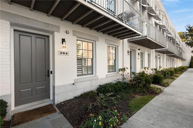 entrance to property featuring brick siding