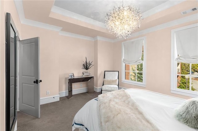 carpeted bedroom featuring baseboards, visible vents, a tray ceiling, crown molding, and a notable chandelier