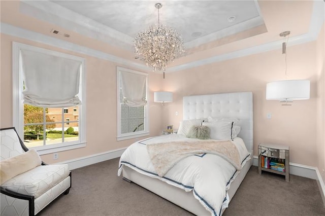 carpeted bedroom featuring a raised ceiling, a chandelier, and baseboards
