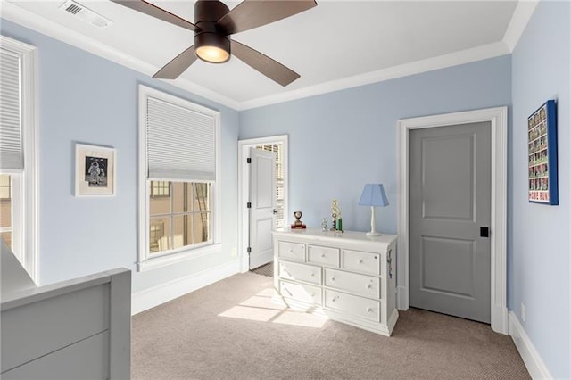 bedroom with light colored carpet, baseboards, crown molding, and ceiling fan