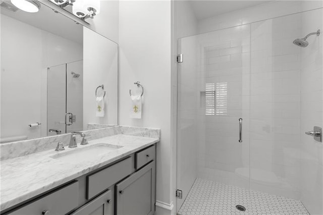 bathroom featuring a stall shower, visible vents, and vanity