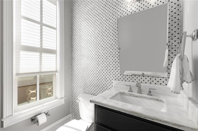 half bathroom with vanity and toilet