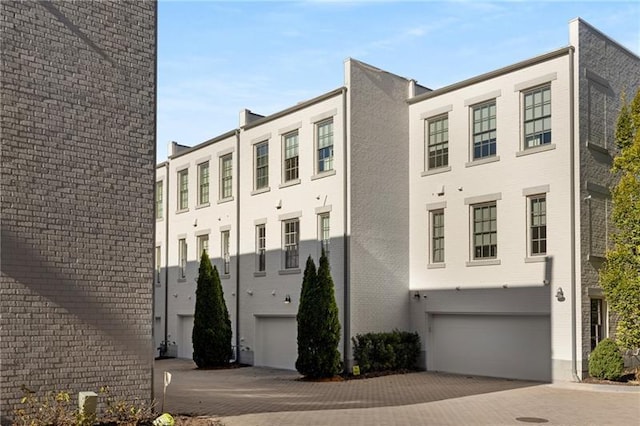 view of building exterior featuring a garage and driveway