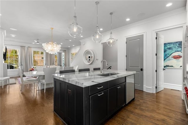 kitchen with a sink, dishwasher, dark wood-style floors, and dark cabinets