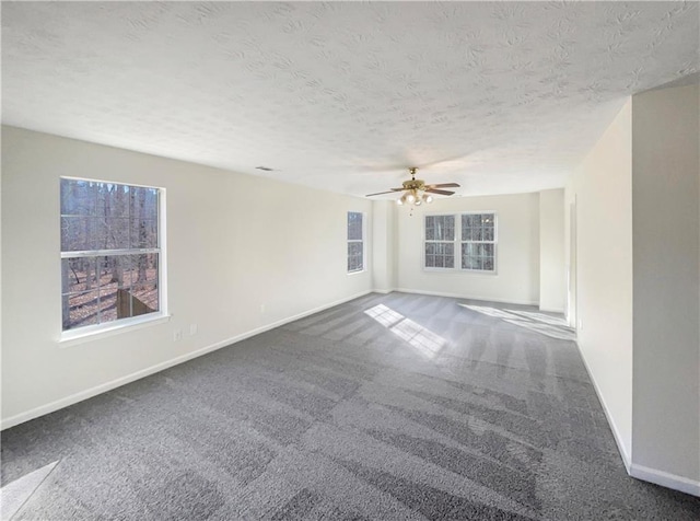 carpeted empty room with a textured ceiling and ceiling fan