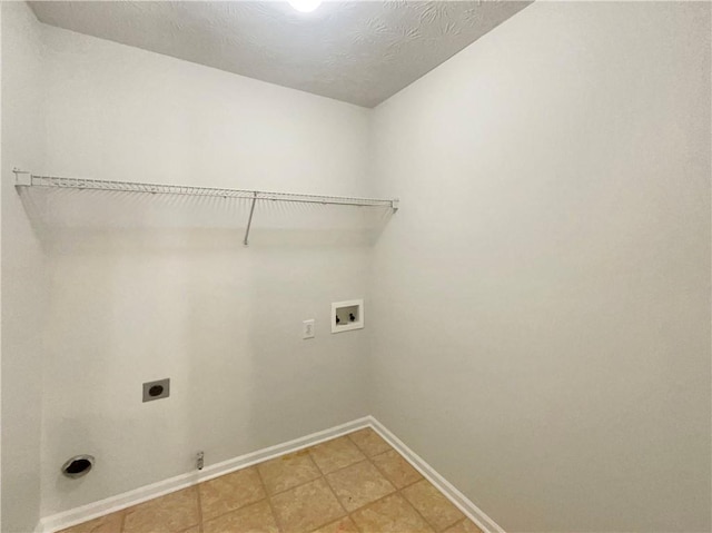 washroom with hookup for an electric dryer, gas dryer hookup, a textured ceiling, and washer hookup