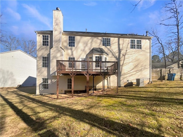 back of house featuring a yard and a wooden deck