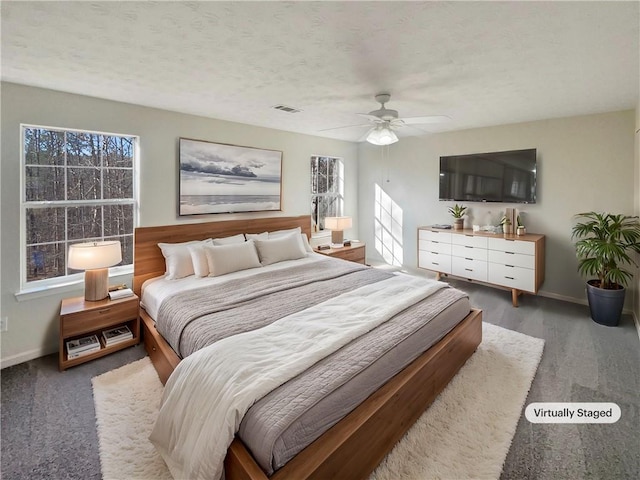 bedroom featuring hardwood / wood-style floors, ceiling fan, and a textured ceiling