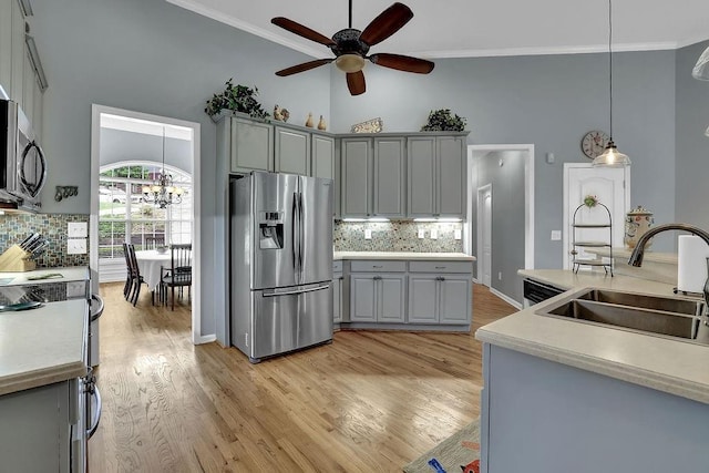 5581 River Valley Way, Flowery Branch, GA 30542 - kitchen featuring appliances with stainless steel finishes, a sink, gray cabinets, ceiling fan, and backsplash