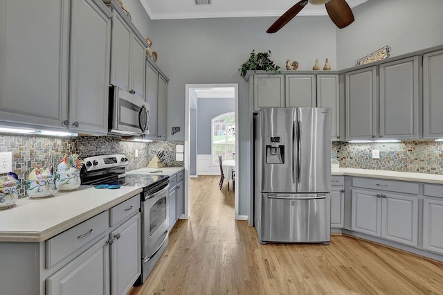 5581 River Valley Way, Flowery Branch, GA 30542 - kitchen with appliances with stainless steel finishes, gray cabinetry, a ceiling fan, light wood-style flooring, and ornamental molding