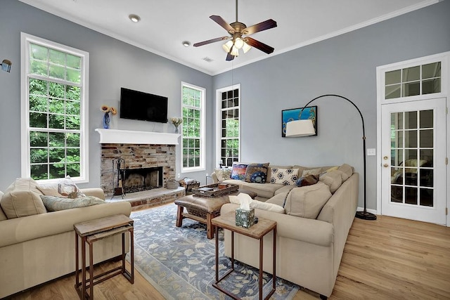 5581 River Valley Way, Flowery Branch, GA 30542 - living area featuring ceiling fan, healthy amount of natural light, wood finished floors, a fireplace with raised hearth, and ornamental molding