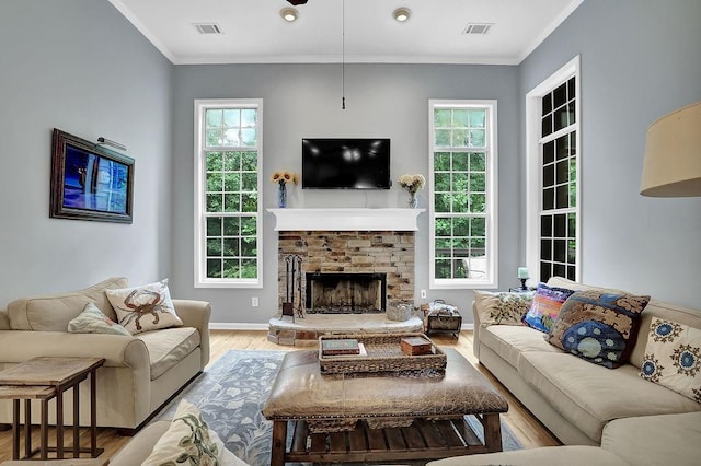 5581 River Valley Way, Flowery Branch, GA 30542 - living room featuring wood finished floors, a fireplace, baseboards, and crown molding