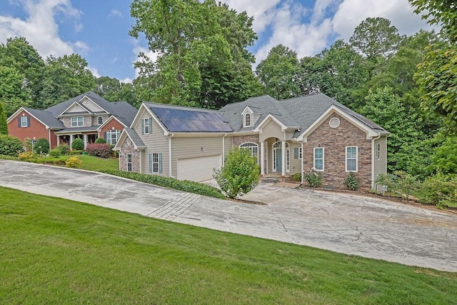 5581 River Valley Way, Flowery Branch, GA 30542 - traditional-style home with concrete driveway, stone siding, a front yard, and a garage