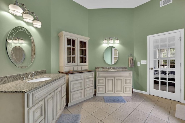 5581 River Valley Way, Flowery Branch, GA 30542 - full bath with a towering ceiling, two vanities, tile patterned floors, and baseboards