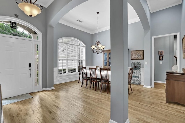 5581 River Valley Way, Flowery Branch, GA 30542 - entrance foyer featuring arched walkways, a chandelier, light wood-type flooring, plenty of natural light, and crown molding