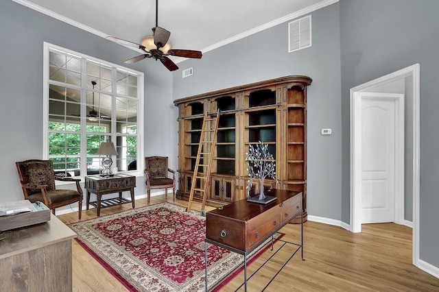 5581 River Valley Way, Flowery Branch, GA 30542 - sitting room featuring a ceiling fan, baseboards, wood finished floors, and crown molding