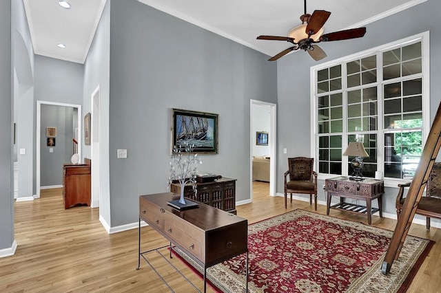 5581 River Valley Way, Flowery Branch, GA 30542 - living area with baseboards, a towering ceiling, light wood-type flooring, ceiling fan, and ornamental molding