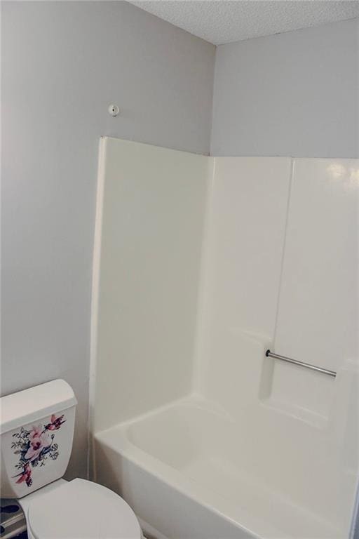 bathroom with toilet and a textured ceiling