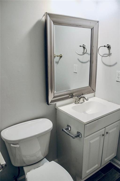 half bathroom with toilet and vanity