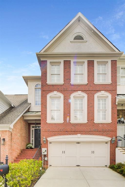195 Mystic Ct, Atlanta, GA 30342 - view of front of property with an attached garage, driveway, brick siding, and stucco siding