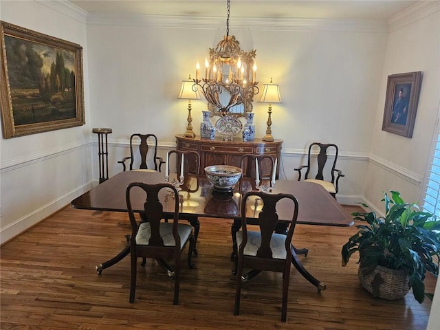 dining room with baseboards, ornamental molding, dark wood-style flooring, and an inviting chandelier