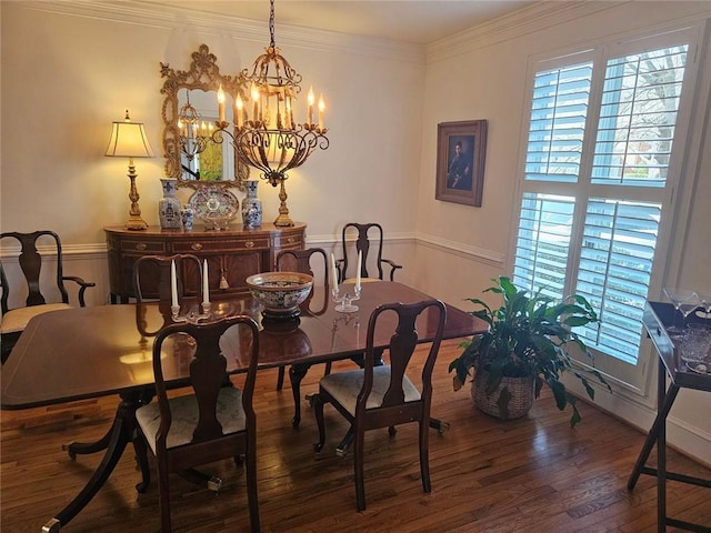 dining space with ornamental molding, a notable chandelier, and dark wood finished floors