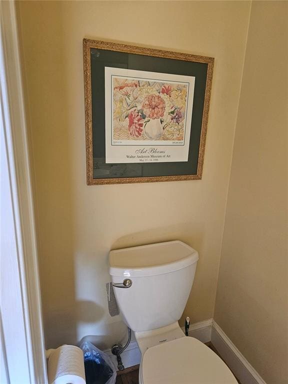 bathroom with baseboards and toilet