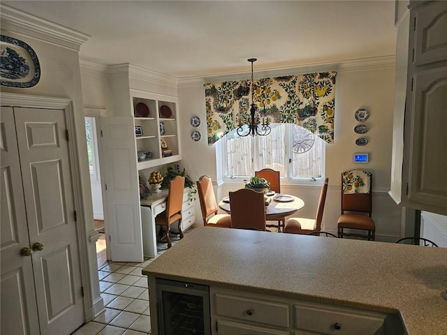 kitchen featuring beverage cooler, hanging light fixtures, a notable chandelier, and crown molding