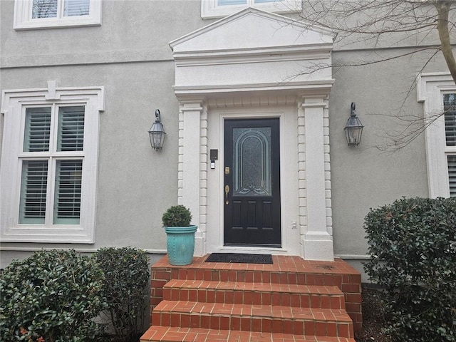 doorway to property with stucco siding