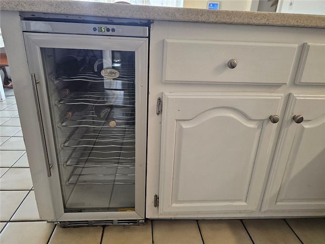 interior details featuring beverage cooler and white cabinetry