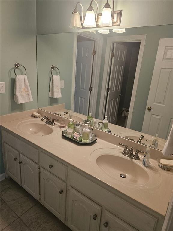 full bath with tile patterned floors, a sink, and double vanity