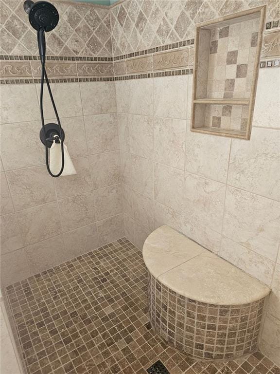 bathroom with a tile shower