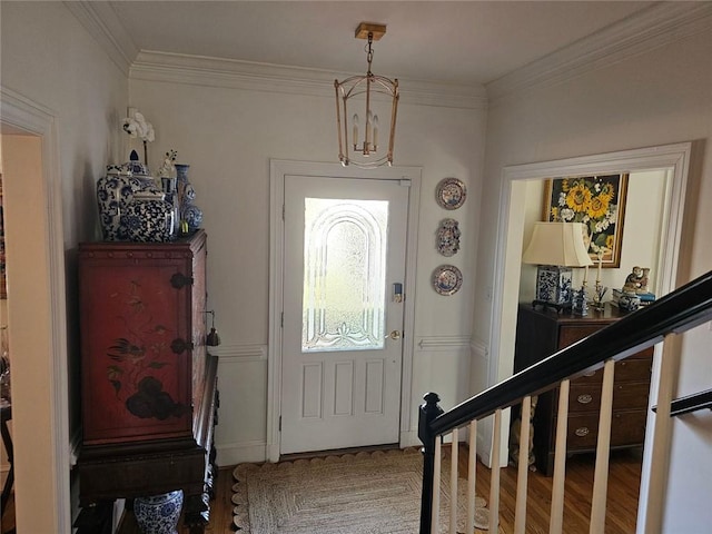 foyer entrance featuring stairway, wood finished floors, and crown molding