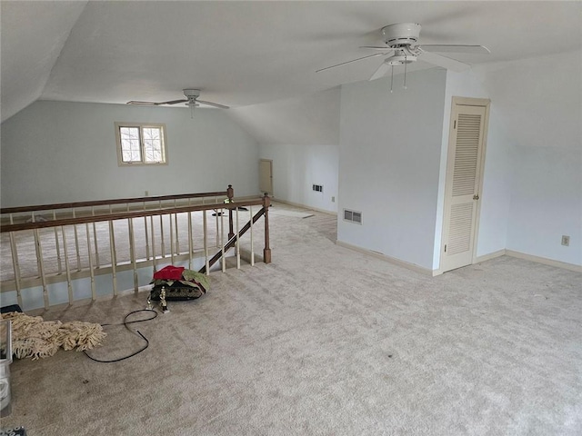 bonus room featuring light colored carpet, vaulted ceiling, visible vents, and baseboards