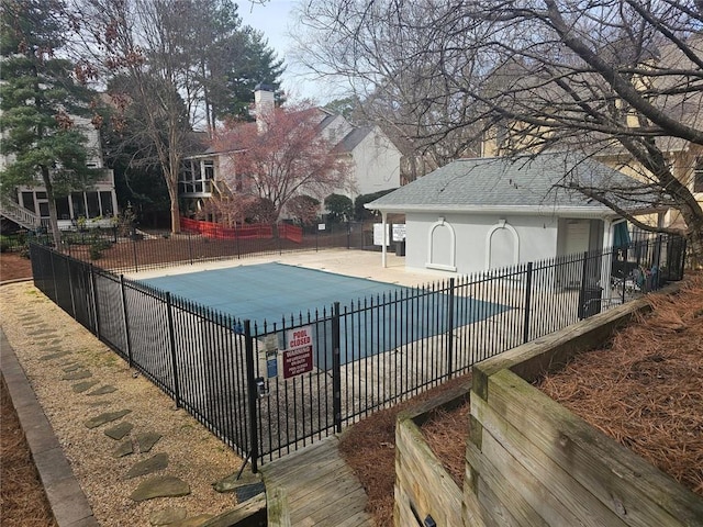 community pool featuring a patio and fence