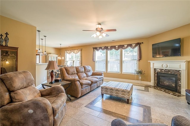 2235 Well Springs Dr, Buford, GA 30519 - living area featuring baseboards, a ceiling fan, a fireplace, and inlaid floor details