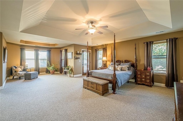 2235 Well Springs Dr, Buford, GA 30519 - bedroom featuring light carpet, a raised ceiling, and baseboards