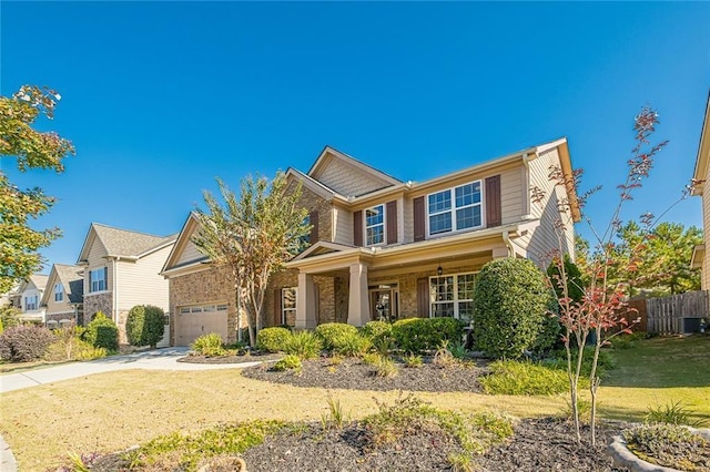 2235 Well Springs Dr, Buford, GA 30519 - craftsman-style house featuring concrete driveway, a porch, a garage, and brick siding