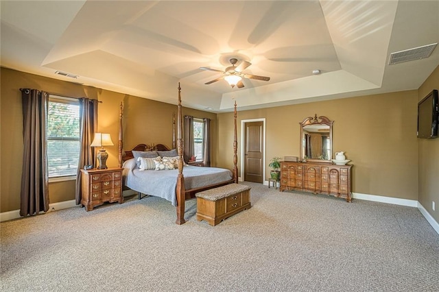 2235 Well Springs Dr, Buford, GA 30519 - bedroom with a tray ceiling, light colored carpet, and multiple windows
