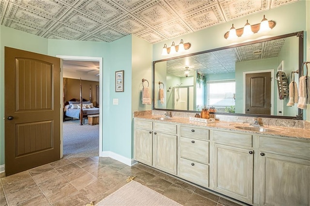 2235 Well Springs Dr, Buford, GA 30519 - ensuite bathroom featuring an ornate ceiling, double vanity, baseboards, and a shower stall