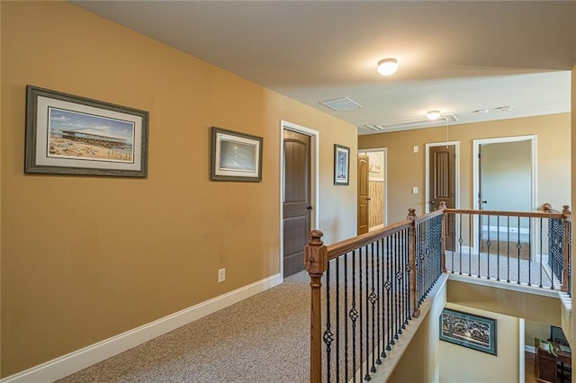 2235 Well Springs Dr, Buford, GA 30519 - hall featuring attic access, an upstairs landing, baseboards, and carpet floors