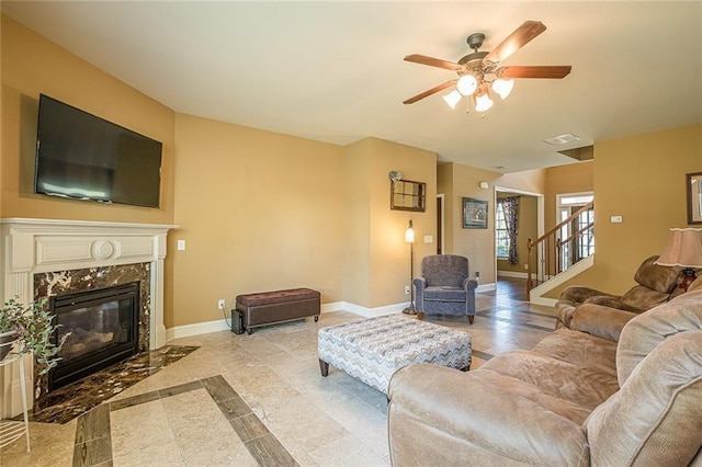 2235 Well Springs Dr, Buford, GA 30519 - living area featuring ceiling fan, baseboards, a premium fireplace, and stairway