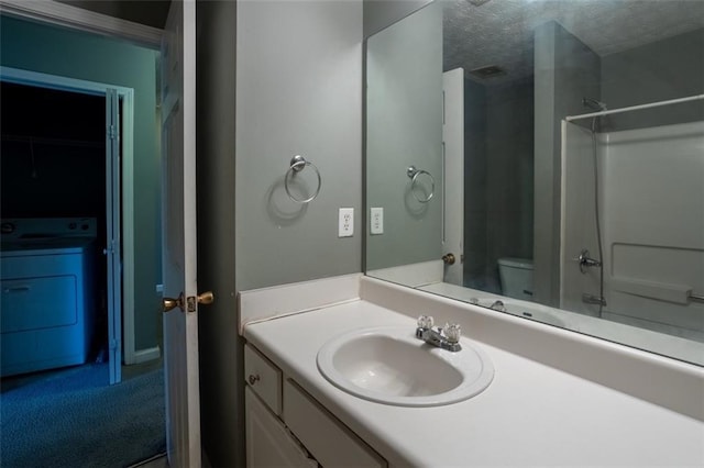 full bath with toilet, washer / dryer, a textured ceiling, and vanity