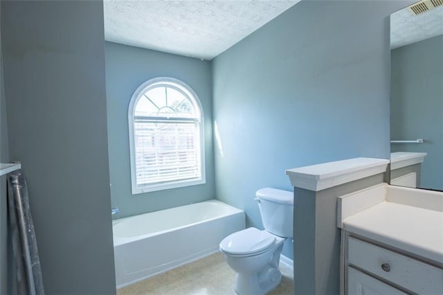 bathroom with visible vents, toilet, a textured ceiling, vanity, and a tub