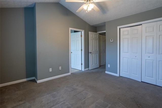 unfurnished bedroom with carpet floors, a closet, vaulted ceiling, ceiling fan, and baseboards