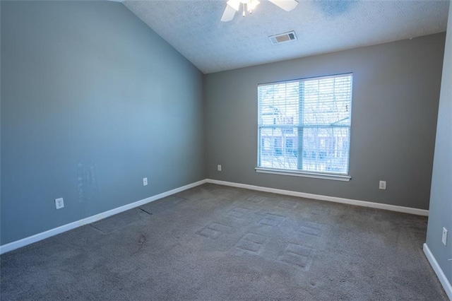 unfurnished room with baseboards, visible vents, a ceiling fan, vaulted ceiling, and a textured ceiling