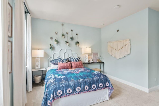 bedroom featuring carpet and baseboards