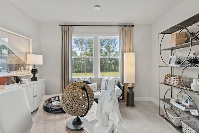 dining area featuring light carpet and baseboards